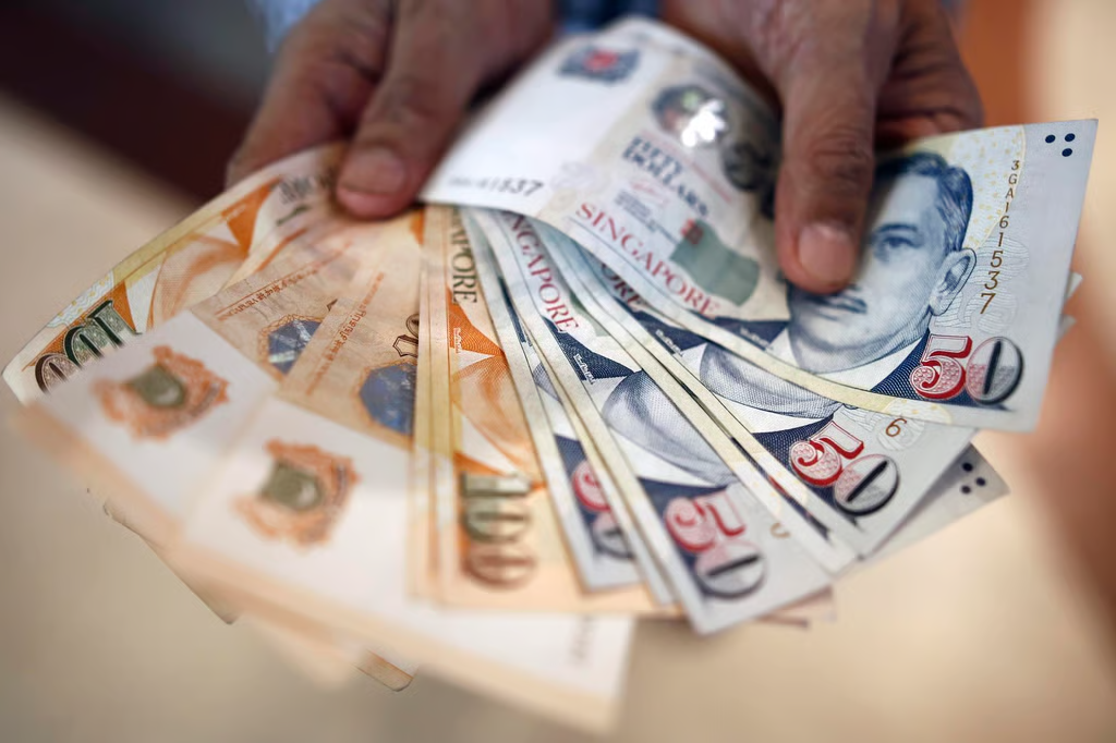 Singapore dollar notes showing cost savings with serviced offices for rent in Singapore.