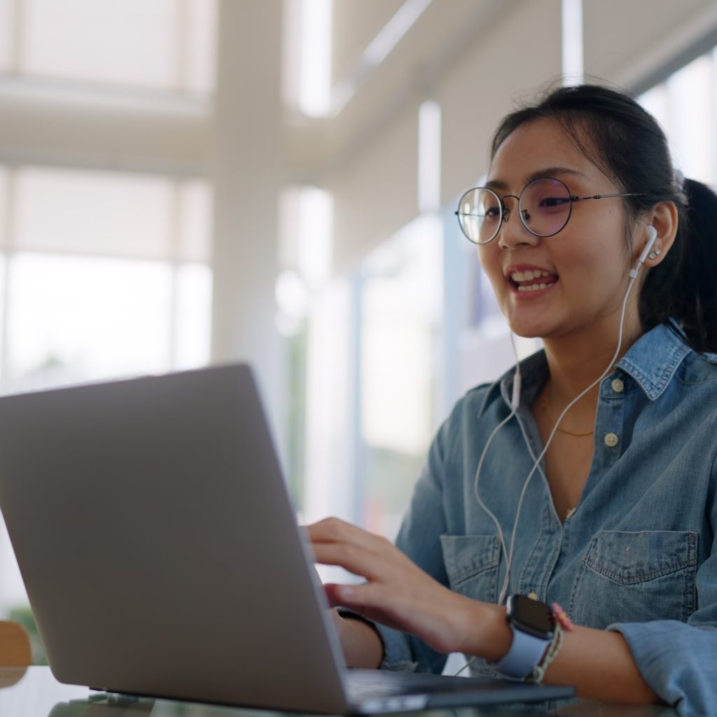 Young entrepreneur working remotely on a laptop, supported by a virtual office solution in Singapore.