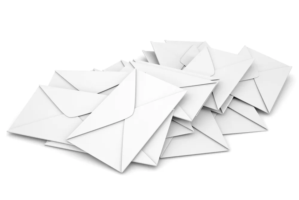 Scattered pile of mail envelopes on a white background. A virtual office in Singapore provides mail handling and forwarding services.