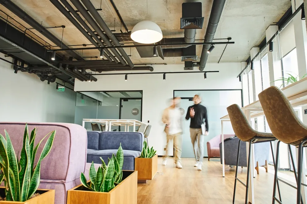 long exposure shot of a coworking space, indicating a busy working environment. A virtual office in Singapore provides coworking spaces for founders.