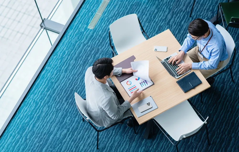 two officeman working together at a meeting room offered in a virtual office package in Singapore